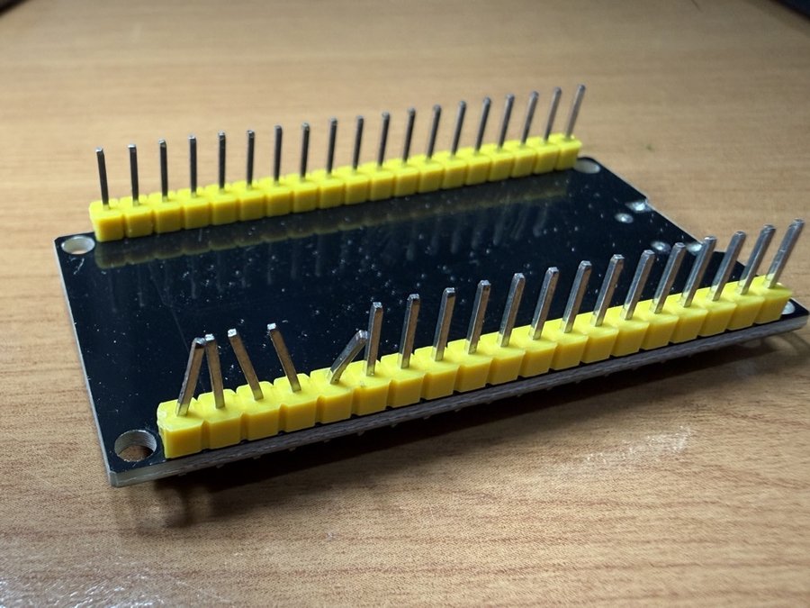 Close-up photo of a hand-soldered PCB with a bent header pin, the actual test image used for the model's visual inspection demo